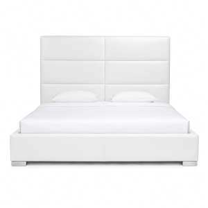 Jules Custom Bed featuring a modern white upholstered paneled headboard and low-profile platform frame in a luxurious minimalist bedroom setting.